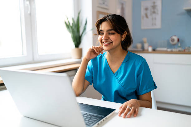CNA nursing student studying on laptop